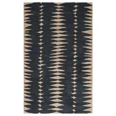 a brown and white rug with an abstract design on the bottom, in front of a white background