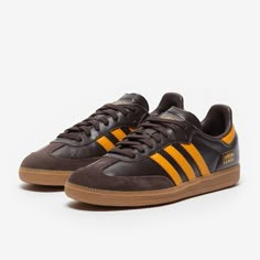 Rule the streets and the pitch with the adidas Originals Samba OG in Dark BrownPremium YellowGum 4, featuring an iconic 3stripes look in smooth leather and reinforced toe, straight from the archives. The adidas Originals Samba OG is a revisit to the classic Samba design, still relevant and sliding onto your feet for superb style over 70 years later. Smooth leather and serrated 3stripe overlays looks just as good now as they did back in the day, adding a touch of retro archive style to your daily Adidas Brown Shoes, Adidas Shoes Brown, Sporty Brown Adidas Skate Shoes, Adidas Samba Chalky Brown, Classic Brown Adidas Sneakers, Trainers Mens, Funky Shoes, Mens Outfit Inspiration, Hype Shoes