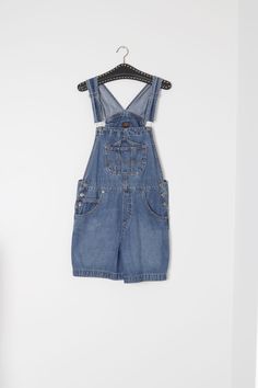 Cute, vintage denim short overalls. The brand is Route 66, well known makers of overalls. These vintage denim short overalls features a hammer loop on the back pocket. Shorten or length them with the adjustable clasp straps. The denim is medium weight and has a dark wash. The condition of these vintage denim short overalls is very good, with no marks to mention.   Marked size M.  Best fits up to size 12 Aus, US size 8 Measurements taken lying flat.-             Waist (doubled) -    88  cm/   35   inch             Hips  (doubled-     94  cm/    37  inch            Inseam-     11 cm/    4 inch            Thigh -  32 cm/    12.5 inch Cheap Denim Blue Cotton Shortalls, Overall Jeans, Retro Dark Wash Shortalls With Pockets, Vintage Cotton Medium Wash Shortalls, Vintage Denim Shortalls With Bib Front, Vintage Denim Shortalls In Medium Wash, Vintage Denim Bib Front Shortalls, Vintage Denim Blue Cotton Shortalls, Vintage Denim Shortalls