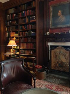 a room with a chair, fireplace and bookshelf