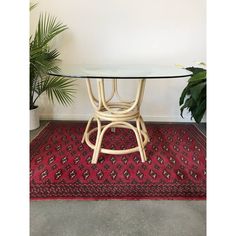 a table with a glass top on a red rug