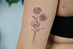 a woman's arm with a flower tattoo on the left side of her body