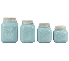 four blue mason jars are lined up in a row