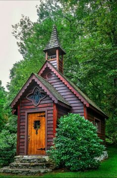 a small wooden building with a steeple on top