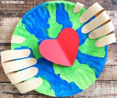 paper plate craft with hands holding a heart and the words earth day paper plate crafts on it