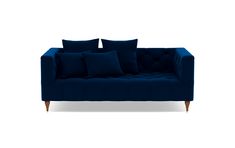 a blue couch with four pillows on it and one arm folded back to the side