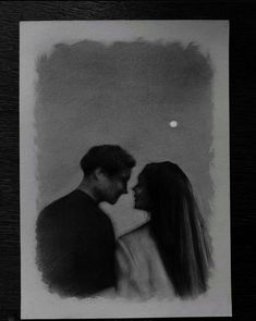 a black and white photo of a man and woman kissing in front of the moon