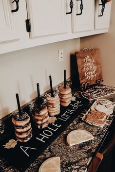 a table topped with cakes and cookies on top of a counter