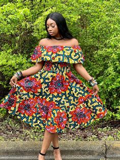 ✨ Make a bold fashion statement with this Ankara Midi Dress, a fusion of contemporary style and traditional African flair.  ✨ Crafted with vibrant Ankara fabric, this Ankara Printed Fit and Flare Dress boasts a flattering fit-and-flare silhouette that accentuates your curves in all the right places. The intricate prints, inspired by African heritage, add a touch of cultural richness to your ensemble. Perfect for both casual outings and special occasions, this dress exudes elegance and charm. Pai Vibrant Bold Print Dresses, Red Dresses With Bold Print, Vibrant Printed Midi Dress, Fitted Bohemian Midi Dress In Multicolor Print, Fitted Bohemian Midi Dress With Multicolor Print, Multicolor Knee-length Dress With Vibrant Print, Orange Bohemian A-line Dress, Bohemian Orange A-line Dress, Vibrant Red Printed Dress