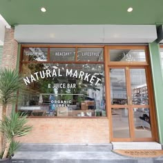 a store front with the words natural market and juice bar on it's side