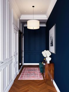 a hallway with blue walls and wooden floors