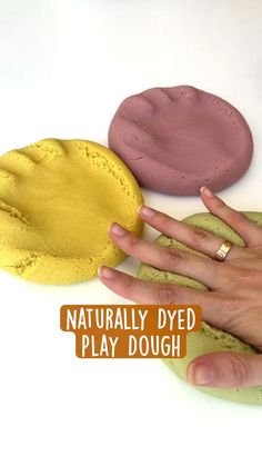 a person's hand next to three different colored doughs with the words naturally dyed play dough on them