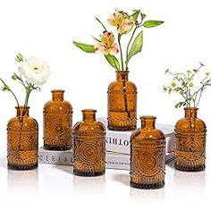 a group of vases with flowers in them