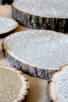 several pieces of wood with white glitter on them