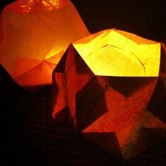 two paper lanterns lit up in the dark