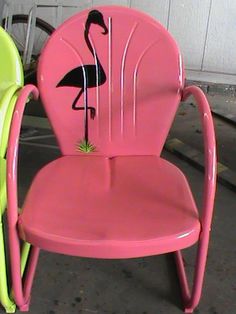 two chairs with flamingos painted on them sitting side by side next to each other