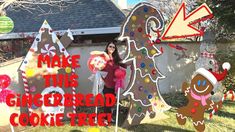 a woman standing in front of a gingerbread cookie tree