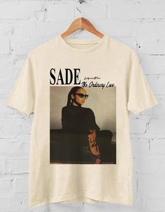 Sade No Ordinary Love T Shirt ,Sade Love album t shirt, Sade shirt, Retro Sade Fan T-shirt Gift for men women unisex tshirt : 100% Cotton (fiber content may vary for different colors) .: Medium fabric (5.3 oz/yd² (180 g/m .: Classic fit .: Runs true to size HOW TO ORDER Pick you favorite design. Review the size & color charts above FIRST and then select shirt size and color from the dropdown menu. Indicate the birthday year in the personalization box. Please note size measurements for t-shirts may differ +/- 1 inch due to the manufacturer. Colors may not exactly match what's shown on screen. Thanks for stopping by my shop. Feel free to reach out for any questions you may have. I appreciate your business. No Ordinary Love, Love T, Tshirt Outfits, Fall Fashion Outfits, Love T Shirt, Unisex Tshirt, Colorful Hoodies, Gift For Men