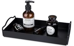 a black tray with some bottles and soaps on it