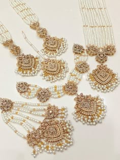 several necklaces with pearls and gold accents