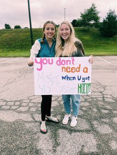 two girls holding a sign that says you don't need a mister u get to sister