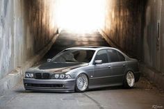 a car parked in a tunnel with the light coming from it's window behind it