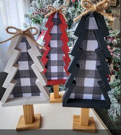 two wooden christmas trees are sitting next to each other