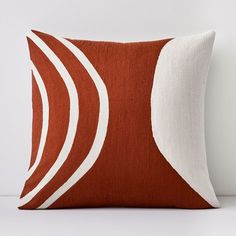 an orange and white pillow sitting on top of a table