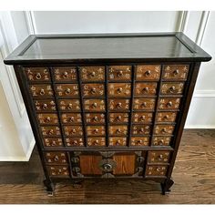 an old wooden cabinet with many drawers