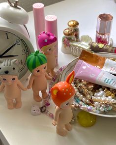 there are many toys on the table and one has a clock in the back ground