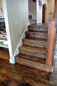 a wooden stair case in a house with wood floors