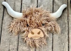 a stuffed animal that is laying down on a wooden floor with it's eyes open