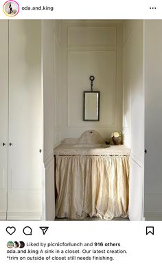 an image of a bed in the corner of a room with white walls and furniture