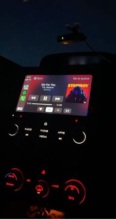 the dashboard of a car at night with an app on it's display screen