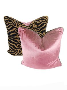 two pink and black pillows with zebra print on the back, one in gold foil