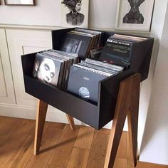 a record player's stand with records in it