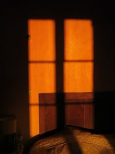 the sunlight is shining through two windows onto a bed