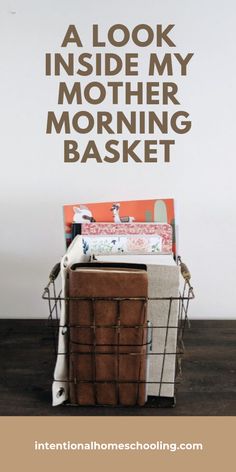 a brown basket sitting on top of a wooden floor next to a wall with words above it