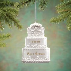 a wedding cake ornament hanging from a christmas tree