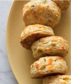 a yellow plate topped with cheesy biscuits