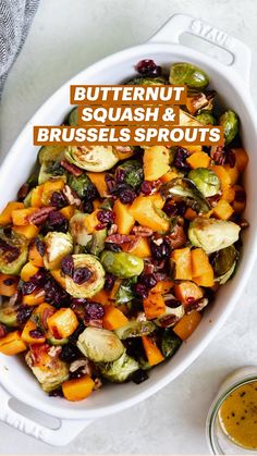 a white bowl filled with brussel sprouts and butternut squash