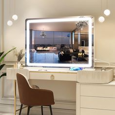 a desk with a large mirror on top of it next to a chair and potted plant