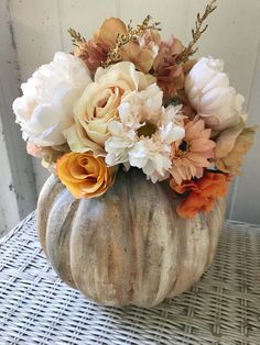 a vase filled with flowers sitting on top of a table