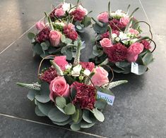 flowers arranged in the shape of a heart on top of a tile floor with a price tag