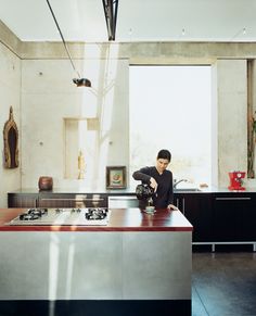 a man sitting at a kitchen counter in front of a window