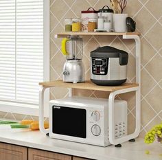 a microwave oven sitting on top of a counter next to a coffee maker and other kitchen items