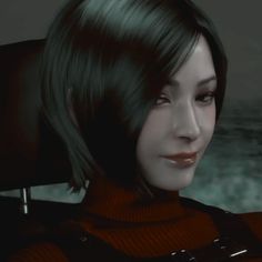 a close up of a person with short hair and wearing a red turtle neck sweater