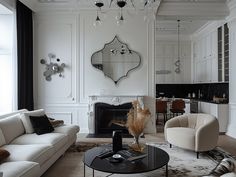 a living room filled with furniture and a fire place under a mirror on the wall