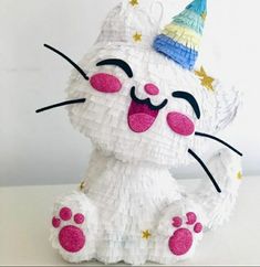 a cat made out of paper with a party hat on