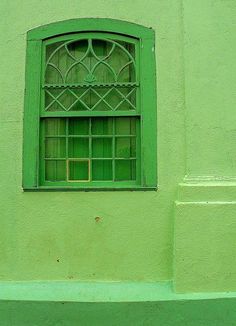 a green window on the side of a building